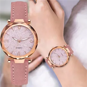 Pink starburst dial quartz watch with rose gold case and matching leather strap on wrist