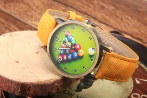 Close-up of retro bronze billiard quartz watch with green dial and yellow fabric strap
