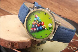 Detail of vintage bronze billiard quartz watch with green pool table dial and blue strap