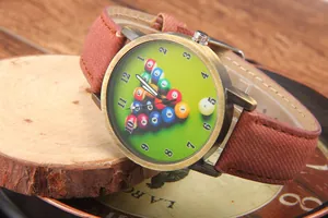 Macro shot of vintage bronze quartz watch with billiards pool table dial and textile strap