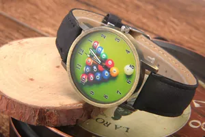 Close-up of vintage bronze quartz watch with billiards theme dial on wooden surface