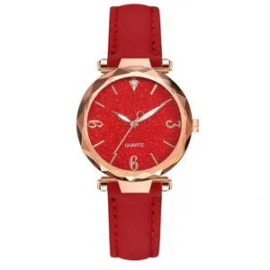 Macro view of rose gold watch case with faceted glass and red glitter dial details