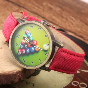 Retro bronze pool table themed quartz watch with a red denim strap on a rustic wood base