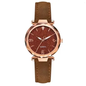 Detail of rose gold quartz watch with brown starry dial and multifaceted glass lens