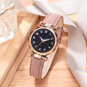 Detail of starry blue dial and faceted glass watch face with pink frosted strap