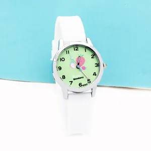 Close-up of children quartz watch with white silicone strap and strawberry pattern dial
