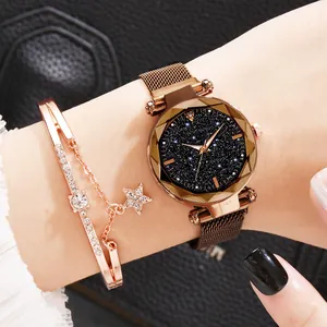 Detail of rose gold starry sky watch and star charm bracelet on a woman's wrist