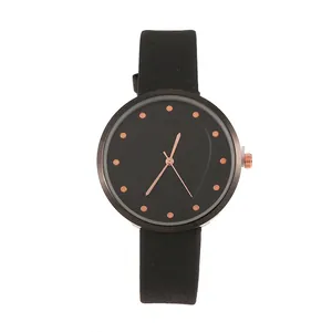 Minimalist black quartz watch with rose gold indices and heart pattern dial detail