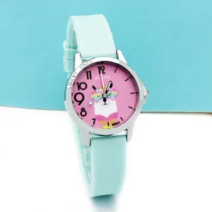 Close-up of mint green silicone watch with lucky child engraving and alpaca dial