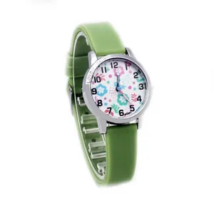 Macro shot of a grass green silicone watch band and floral dial for children