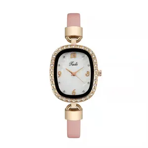 Close-up of pink leather watch with rose gold diamond bezel and marble dial detail