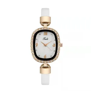 Detail of elegant ladies' oval watch with rhinestone bezel and marble-textured dial