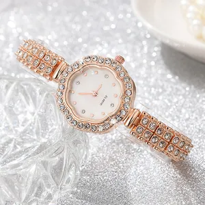 Detail of rose gold quartz watch featuring a crystal bezel and sparkling diamond band