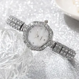 Macro shot of a luxury silver quartz watch with a diamond-encrusted floral bezel design