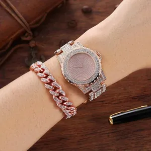 Close-up of luxury rose gold iced-out watch and Cuban link bracelet on wrist