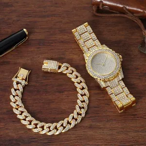 Close-up of luxury gold iced-out watch and cuban link bracelet on dark wood background