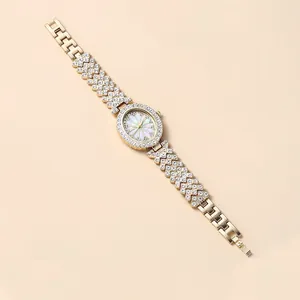 Macro detail of luxury gold oval quartz watch with crystal inlay and floral dial pattern