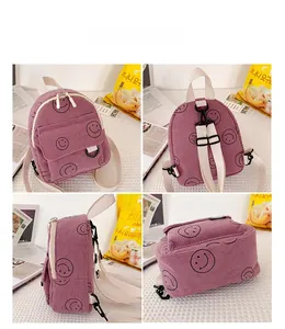 Detail view of purple corduroy backpack with smiley face and adjustable straps