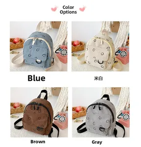 Corduroy smiley face backpacks in blue, off-white, brown, and grey color options