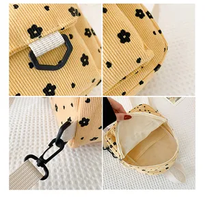 Macro detail of yellow corduroy backpack featuring floral print and plastic buckles