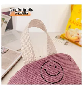 Detail of lavender corduroy tote bag with smiley face print and comfortable handle