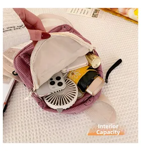 Interior view showing the large capacity of a purple corduroy backpack with smiley face
