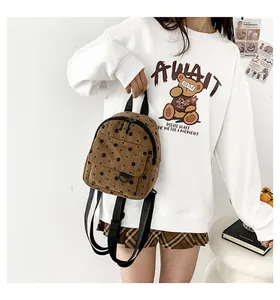 Macro shot of mini corduroy backpack with floral pattern on a lifestyle model
