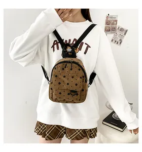 Brown corduroy mini backpack with floral patterns shown in a lifestyle indoor setting