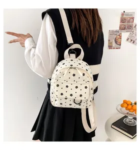 Detail of cream corduroy mini backpack with floral print and adjustable straps