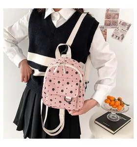 Detail of pink corduroy mini backpack with floral pattern and adjustable straps