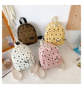 Flat lay of corduroy mini backpacks with floral patterns in brown, yellow, white, and pink