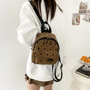 Brown floral corduroy mini backpack with adjustable straps and front zip pocket