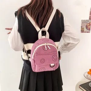 Pink corduroy mini backpack for women with smiley patterns and adjustable straps