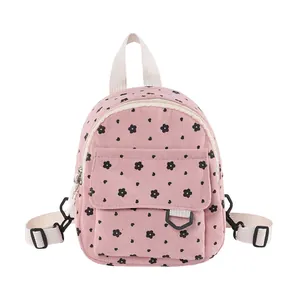 Mini pink corduroy backpack with black floral pattern and adjustable straps for women