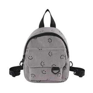 Mini grey corduroy backpack with black smiley face pattern and adjustable straps