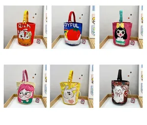 Detailed close-up of colorful canvas bucket bags with cute cartoon rabbit illustrations