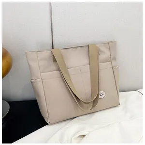 Detailed shot of beige canvas tote bag with functional pockets and Good luck cloud patch
