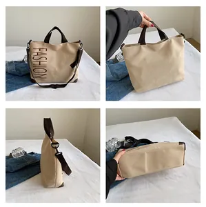 Detail view of khaki canvas tote bag showing front, back, side and bottom reinforced base