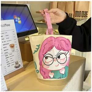 Close-up of canvas bucket bag featuring a cute cartoon girl print and pink handles