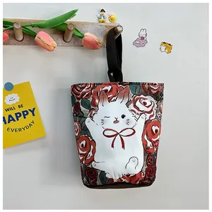Detail of canvas bucket bag with cute cartoon rabbit and red rose flower patterns