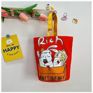 Detail of red canvas bucket bag featuring cute cartoon cat and Rich illustration