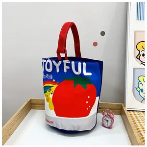 Detail of canvas bucket bag with joyful tomato and cartoon tiger illustration design