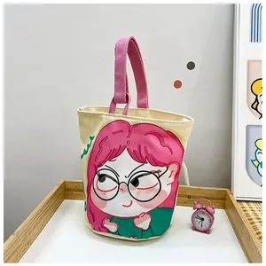 Detailed shot of canvas tote bag with cartoon illustration and pink fabric handles
