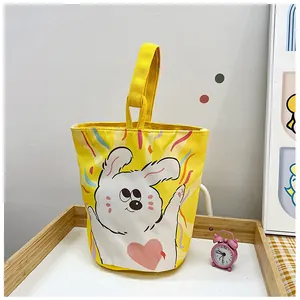 Detail of yellow canvas bucket bag with cute bunny print and sturdy carrying handle