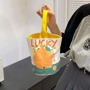Canvas bucket bag with lucky tiger illustration, creamy white body and yellow handles