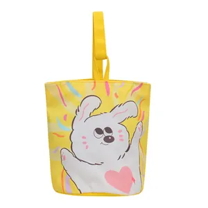 Cute yellow canvas bucket bag featuring a cartoon white rabbit illustration and top handle