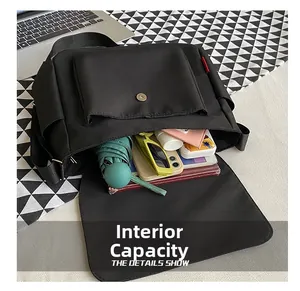 Detailed view of the black messenger bag interior with large storage capacity for gadgets