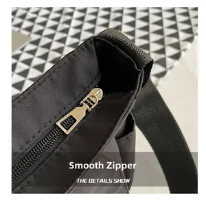Close-up of smooth metal zipper and durable fabric on the black crossbody bag