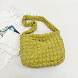 Detailed macro view of the lime green ruched cloud bag showing soft bubble texture fabric