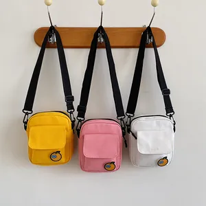 Mini canvas crossbody bags for women in yellow, pink and white with orange embroidery